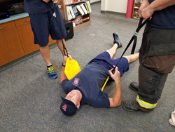 Firefighters demonstrating harness usage