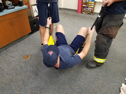 Firefighters demonstrating harness usage