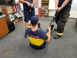 Firefighters demonstrating harness usage
