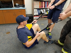 Firefighters demonstrating harness usage