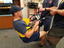 Firefighters demonstrating harness usage